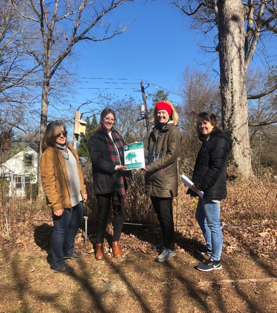 Community project: Pandra Williams looking on as Laura Hennighausen, Executive Director, is being presented with the Wildlife Habitat Certification sign by Atlanta Audubon Society Board Members Melinda Langston and Leslie Edwards.